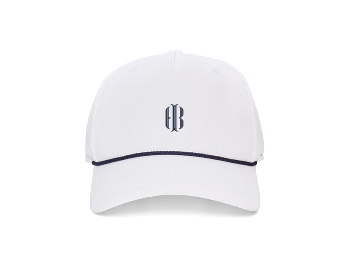 The Performance Rope Hat: White with HB Icon features a six-panel design, navy rope accent, embroidered monogram, UPF 50+ protection, and adjustable snap-back closure.