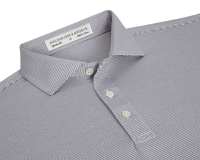 The Perkins Shirt: Gray & White, features a finely striped polo design with a structured collar, three-button placket, and performance fabric for comfort and protection.