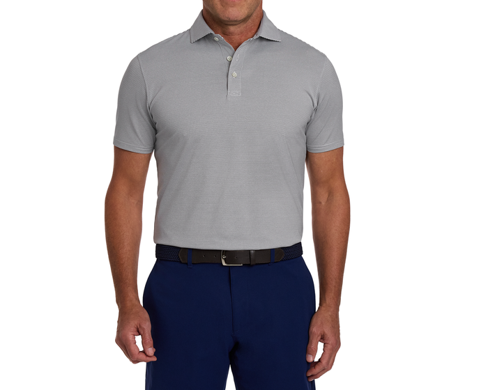 Man wearing The Perkins Shirt: Gray & White, featuring subtly striped light-gray fabric, tucked into navy trousers, with a dark woven belt and silver buckle.