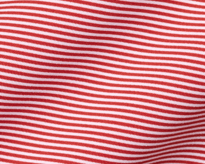 Close-up of The Perkins Shirt: Liberty Red & White, showcasing its fine knit, horizontal stripes, and gentle folds, highlighting its soft, performance fabric texture.