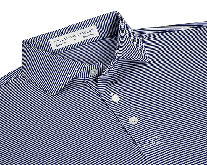 The Perkins Shirt: Navy & White features a micro-stripe knit with a point collar, three-button placket, and moisture-wicking performance fabric for versatile wear.
