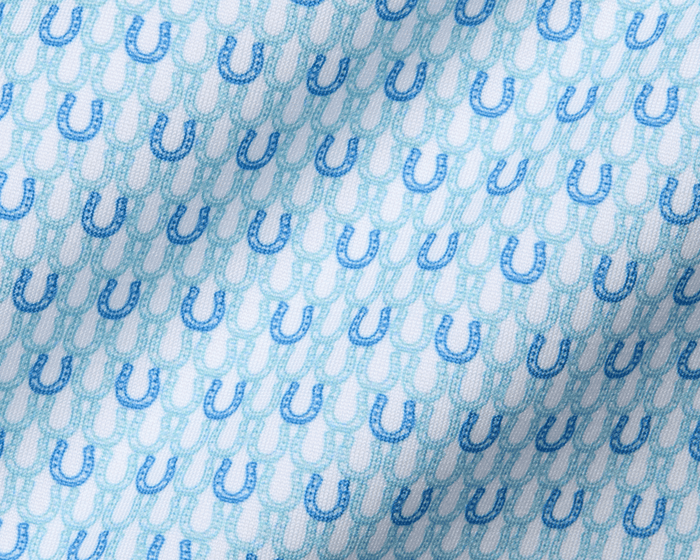The Rivers Shirt in Harbor & Maidstone Blue features a subtle pattern of alternating dark and aqua-blue horseshoes on soft, stretchy jersey fabric.