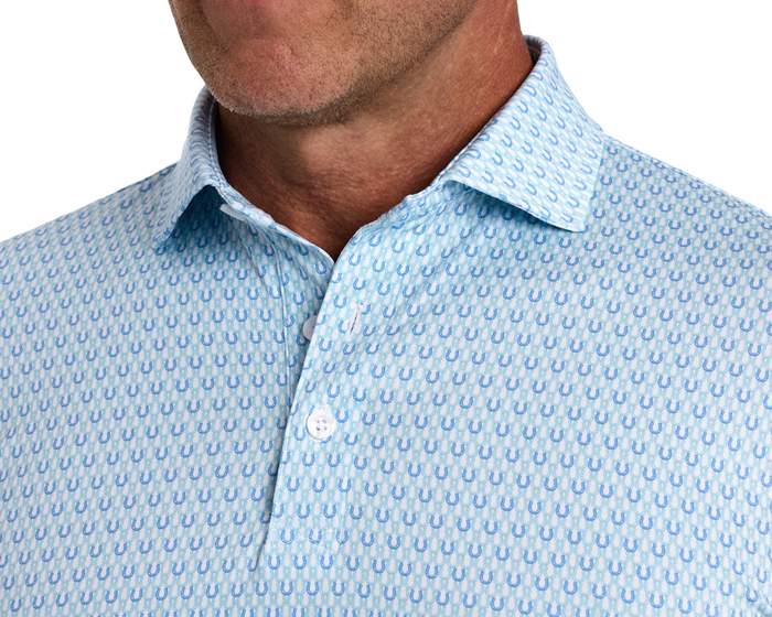 The Rivers Shirt: Harbor & Maidstone Blue features a light-blue dress shirt with a subtle horseshoe pattern, undone top button, and a spread collar for comfort and style.