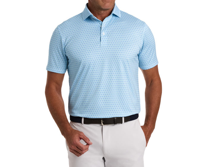 The Rivers Shirt: Harbor & Maidstone Blue, featuring a horseshoe pattern on a light-blue polo, paired with light trousers and a dark belt.