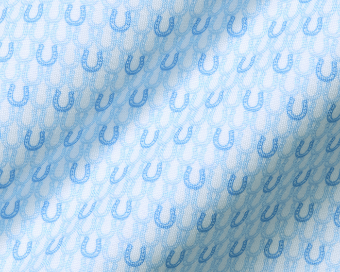 The Rivers Shirt: Vista Blue & Horizon Blue, featuring a soft jersey fabric with light-blue horseshoe motifs on a subtle background, showcasing its breathable, moisture-wicking design.