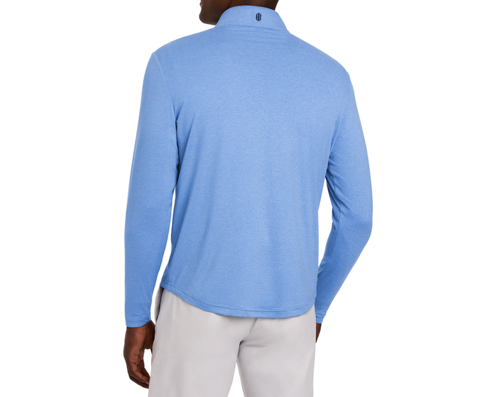 The Royce Quarter-Zip: Heathered Horizon Blue, featuring a textured pullover with a back logo, worn over light-gray trousers, ideal for golf or office settings.