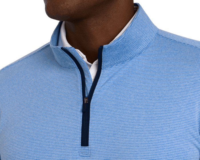 The Royce Quarter-Zip: Heathered Horizon Blue, featuring light blue stripes, stand-up collar, navy zipper, over a white shirt, crafted from lightweight, performance stretch material.