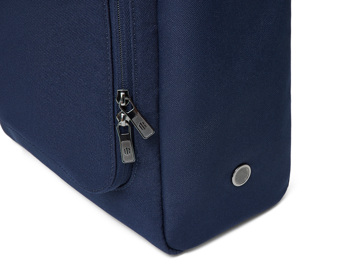 Close-up of The Rutledge Shoe Bag: Navy Ballistic, showing a vertical zipper with silver pull-tabs and a metal grommet on the fabric.
