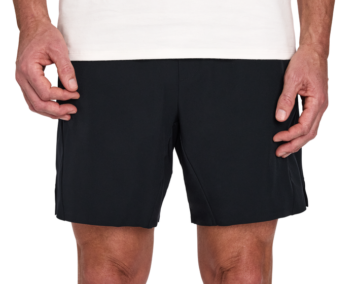 Person wearing The Saunders Short: Black, featuring a quick-drying tech blend and four-way stretch, with hands resting at sides.