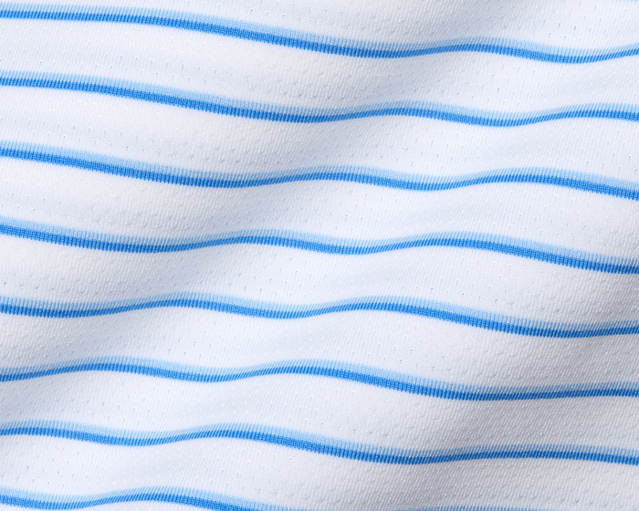 Close-up of The Springer Shirt in white knit with light-blue stripes, showcasing its breathable perforated texture and gentle folds, designed for peak performance.