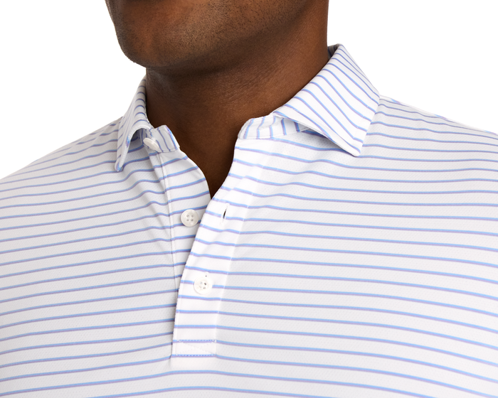 Person wearing The Springer Shirt: White/Vista Blue/Tudor, featuring light blue stripes, open collar, and buttons, crafted from ultra-breathable AIRATION® fabric with performance features.