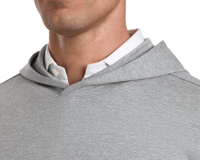 The Stowe Hoodie: Heathered Gray on a man, highlighting its lightweight fabric, set-in sleeves, and athletic drop-tail hem, layered over a white shirt.