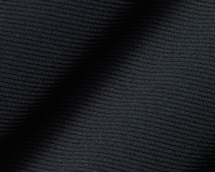 The Stuart Quarter-Zip: Black, showcasing a close-up of its dark ribbed textile, highlighting the knit's subtle, tightly spaced horizontal rib texture for a refined look.