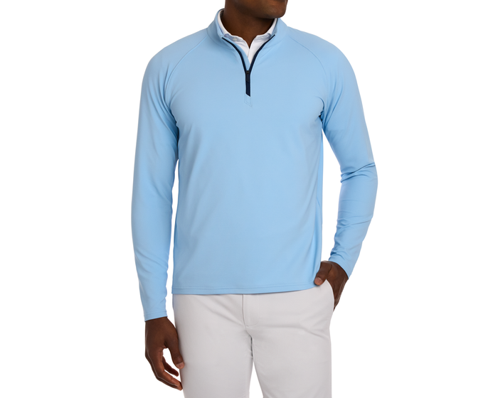 The Stuart Quarter-Zip: Vista Blue worn over a white shirt, featuring a subtle textured rib fabric, paired with light trousers.