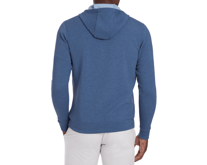 Back view of a person wearing The Tilley Quarter-Zip Hoodie: Heathered Andover, showcasing its sleek silhouette and midweight design, paired with light-colored trousers.