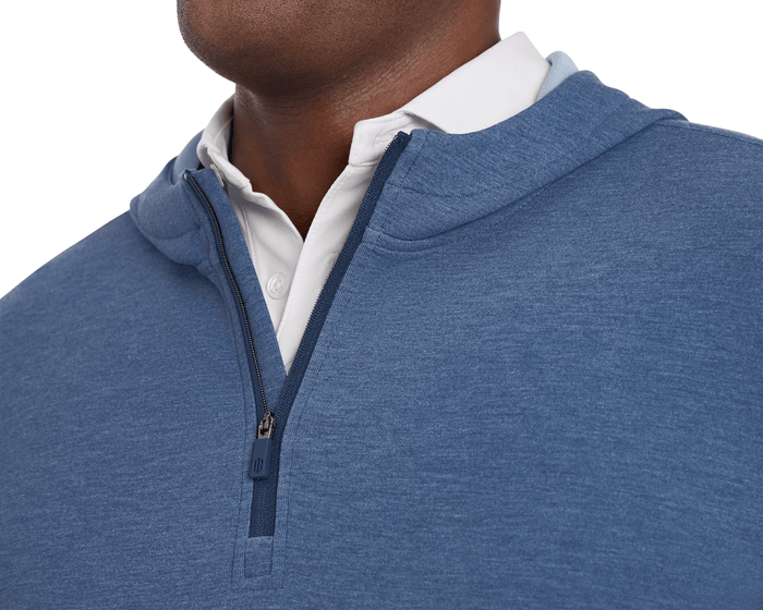 The Tilley Quarter-Zip Hoodie: Heathered Andover, shown over a white collared polo, features a soft, textured fabric with a partially open zipper, ideal for versatile wear.