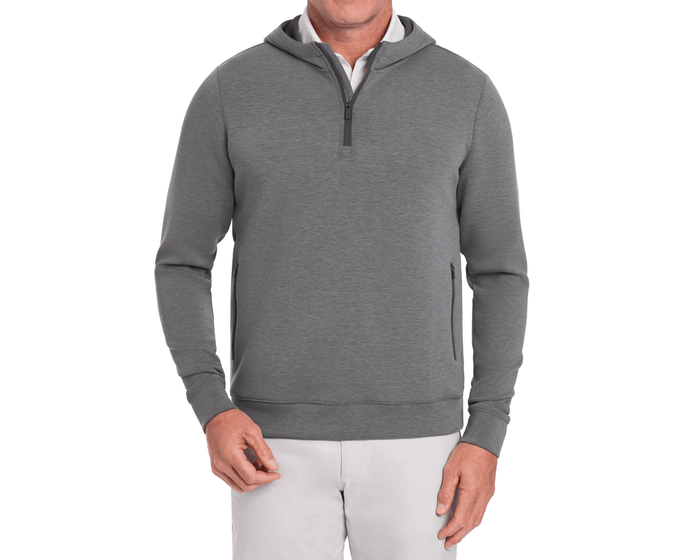 The Tilley Quarter-Zip Hoodie: Heathered Charcoal, featuring a sleek silhouette with a quarter-length zipper, zippered side pockets, paired with a white shirt and light trousers.