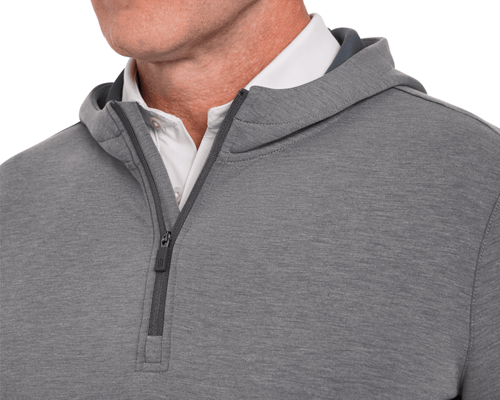 The Tilley Quarter-Zip Hoodie: Heathered Charcoal showcased over a white polo, highlighting its sleek, midweight design ideal for versatile, casual wear.