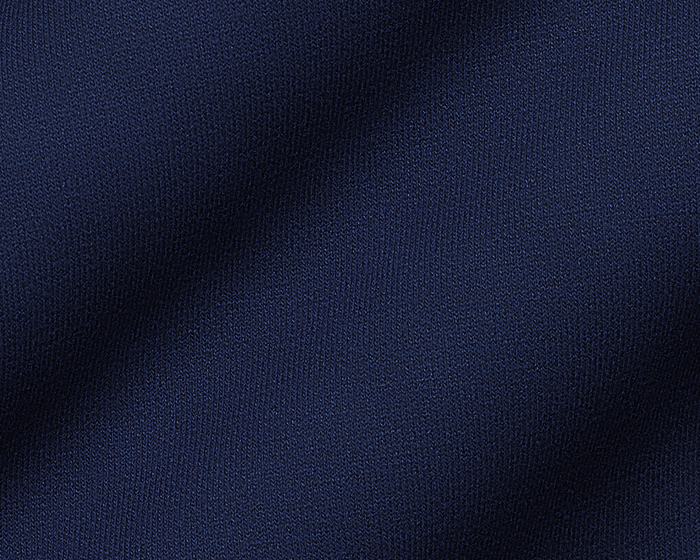 The Tilley Quarter-Zip Hoodie: Heathered Navy showcases a close-up of its intricate knitted texture, highlighting the soft, textured loops ideal for versatile wear.