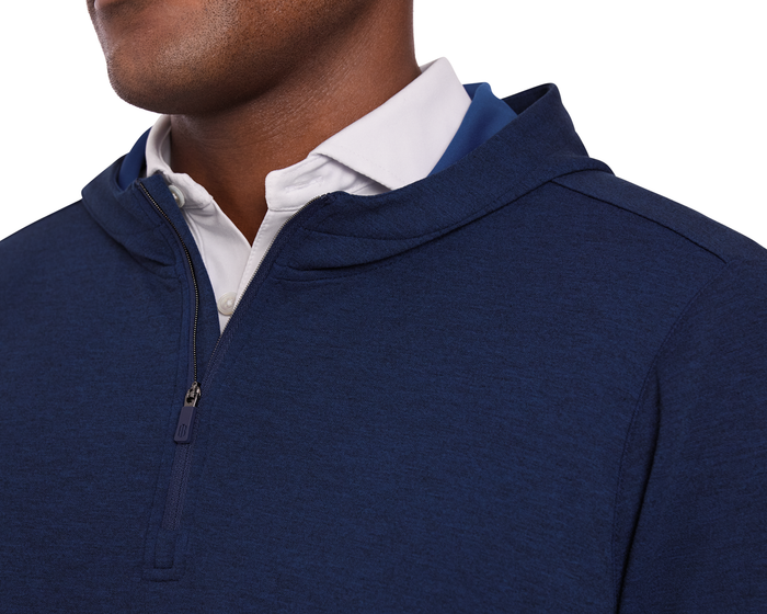 The Tilley Quarter-Zip Hoodie: Heathered Navy, shown layered over a white shirt, features a sleek silhouette and subtle texture, ideal for versatile wear.