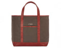 The Travis Tote Bag Cotton Twill: Scotch Green - Rye Embroidery, features a brown canvas with leather trim, monogrammed CMB above a front pocket.