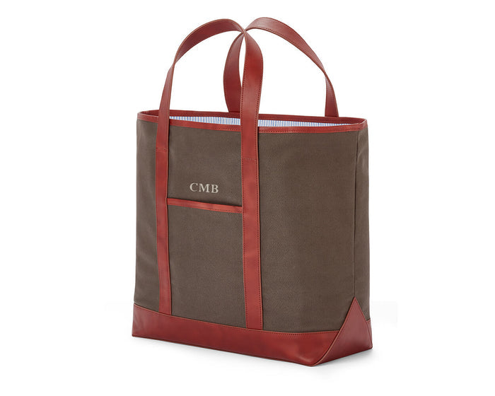 The Travis Tote Bag Cotton Twill: Scotch Green - Rye Embroidery, features a brown canvas with leather trim, front monogram CMB, and striped interior lining.