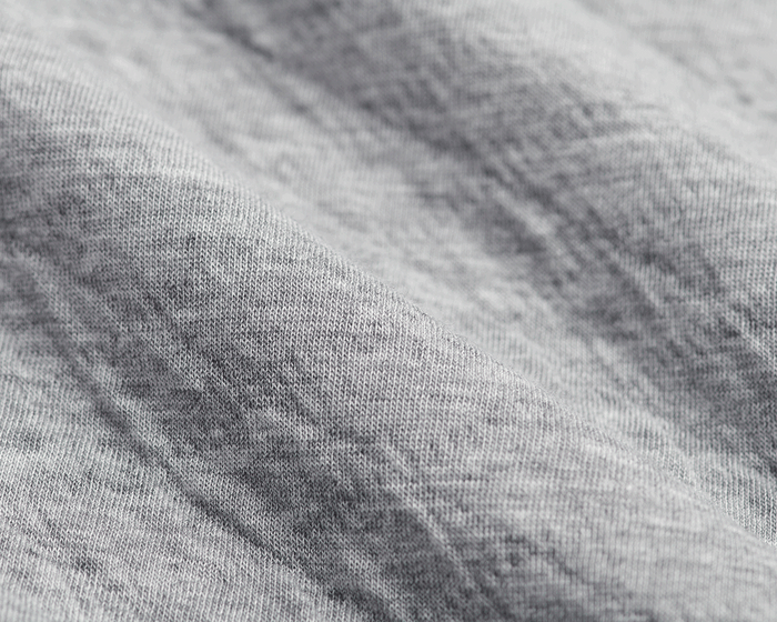 The Van Pelt Blanket: Heathered Gray, close-up of soft, knit fabric texture, showcasing its looped weave, ideal for cozy, stylish comfort.
