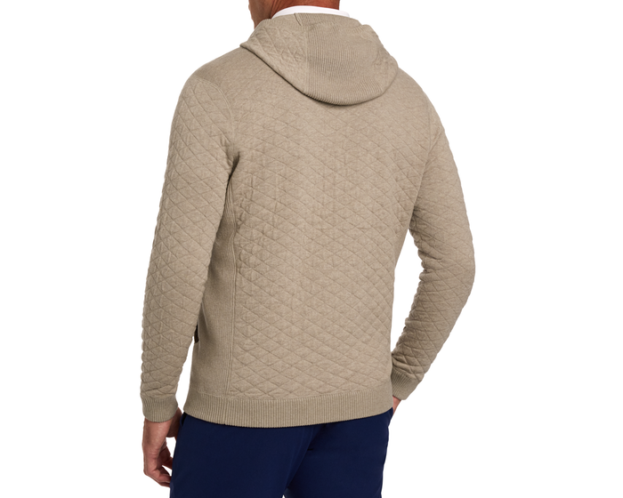 The Wallace Hoodie Sweater: Heathered Light Dune, showcasing a diamond-patterned, quilted knit design, worn by a man with ribbed side panels for a modern fit.