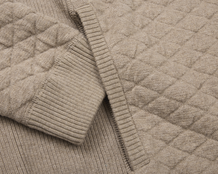 The Wallace Hoodie Sweater: Heathered Light Dune, showcasing its ribbed cuff, hem, and quilted diamond pattern in 100% Egyptian cotton for a modern, streamlined look.