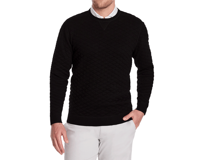 The Ward Crewneck Sweater: Black, featuring a diamond-quilted pattern over a white collar, worn by a male model with light trousers, showcasing its elegant versatility.