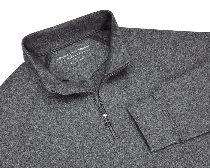 The Westland Boys Quarter-Zip: Charcoal, featuring a heathered design, stand-up collar, and quarter-length zipper, offering UPF 50+ protection and 4-way stretch for comfort.