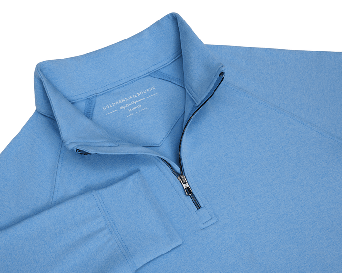The Westland Boys Quarter-Zip in Heathered Vista Blue, featuring a stand-up collar, ribbed cuffs, and a short zipper, laid flat.