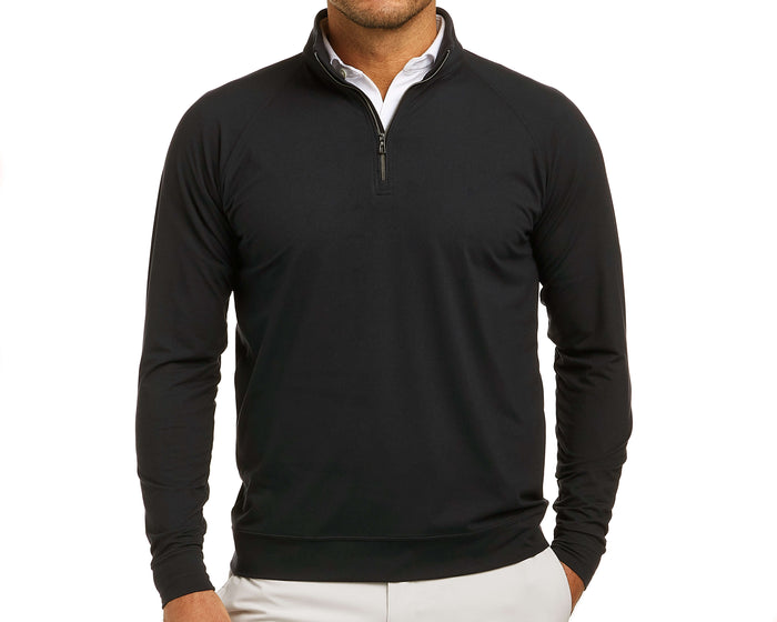 Man wearing The Westland Quarter-Zip: Black, a lightweight, technical pullover over a white shirt, featuring a quarter-zip design with gunmetal chrome trim.