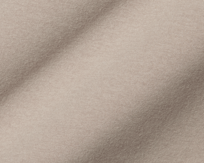 The Westland Quarter-Zip: Heathered Dune, showcasing its fine weave and soft folds, exemplifying moisture-wicking, peached synthetic blend fabric for versatile use.