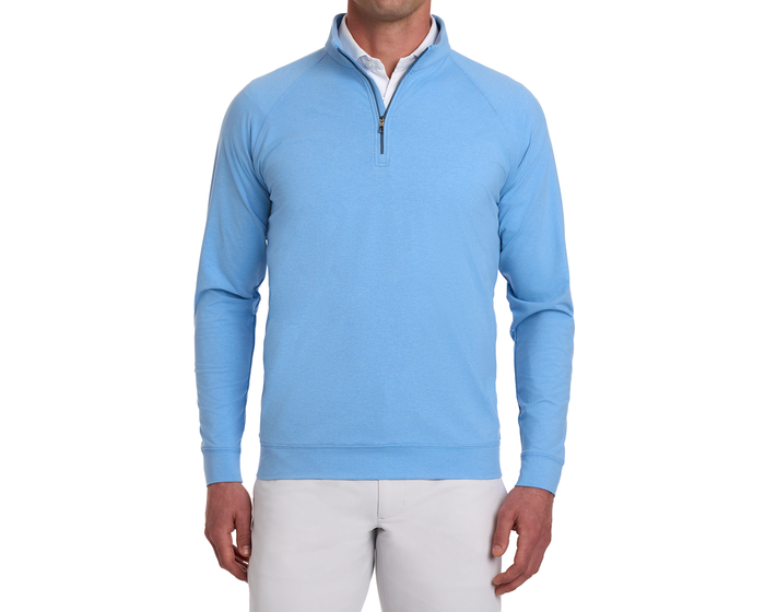Model wearing The Westland Quarter-Zip in Heathered Vista Blue, showcasing its lightweight, moisture-wicking fabric with a soft, peached finish, over a white polo.