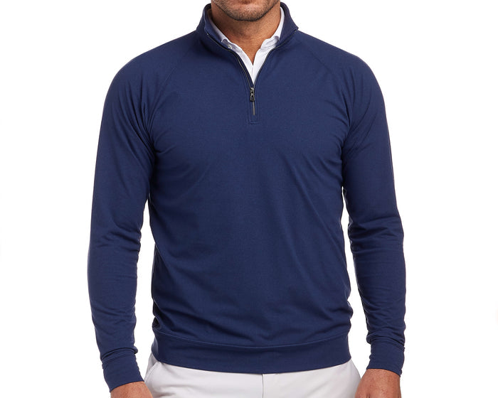 The Westland Quarter-Zip: Navy, shown layered over a white shirt with light trousers, highlights its moisture-wicking, soft peached fabric and versatile heathered design.