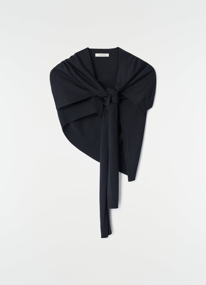 Trompe L'Oeil merino wool scarf in black by LEMAIRE styled flat with knot front detail on white background