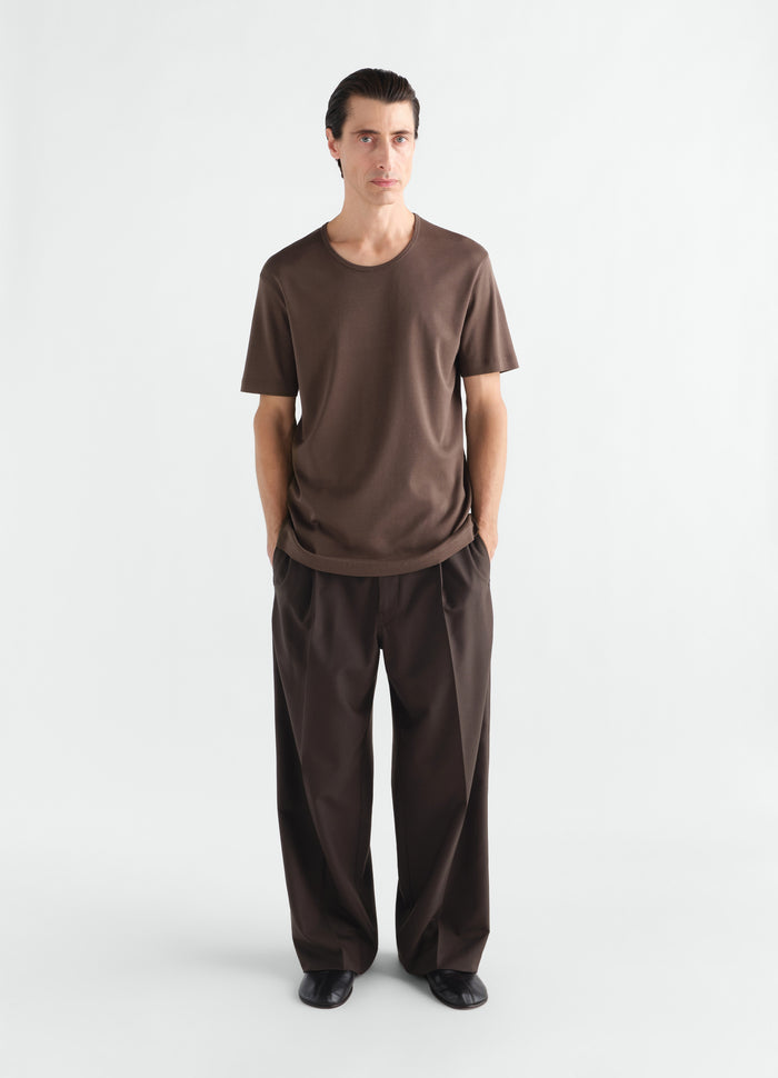 Brown ribbed jersey scoop-neck t-shirt by LEMAIRE worn by a model front view with matching trousers and black shoes
