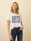 Woman wearing a white t-shirt with blue Florida graphic against a beige background