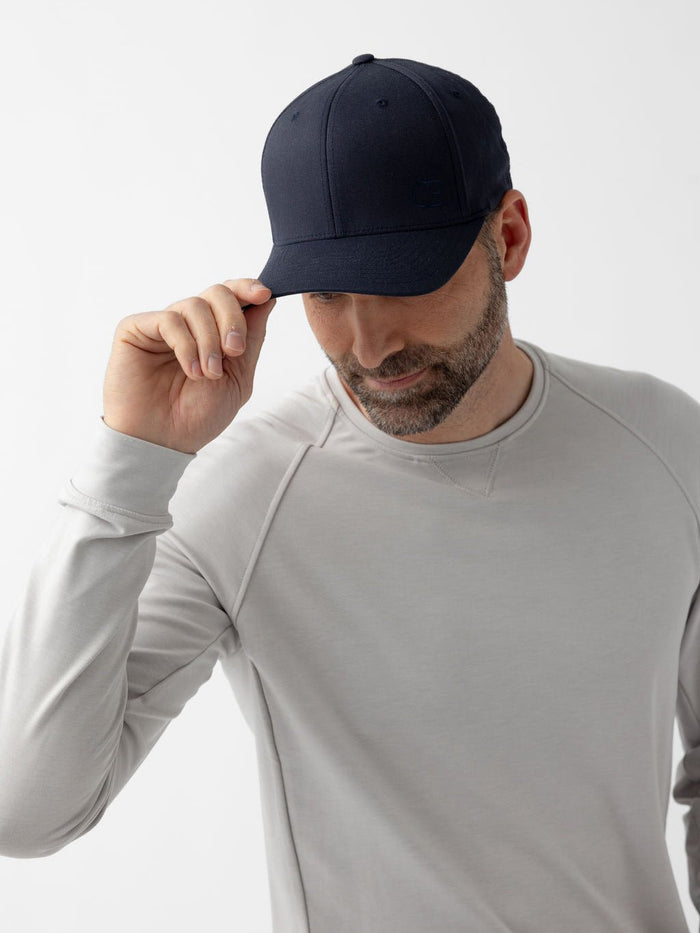 Man wearing navy urban classic hat looking down |Color:Dark Navy