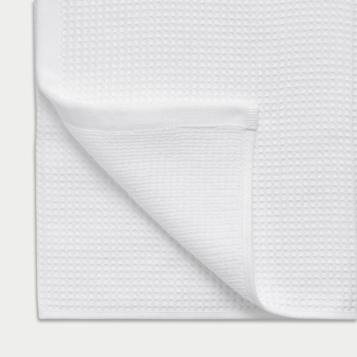 Waffle Bath Towel in the color White. Photo of Waffle Bath Towel taken close up showing the corner of the towel |Color:White