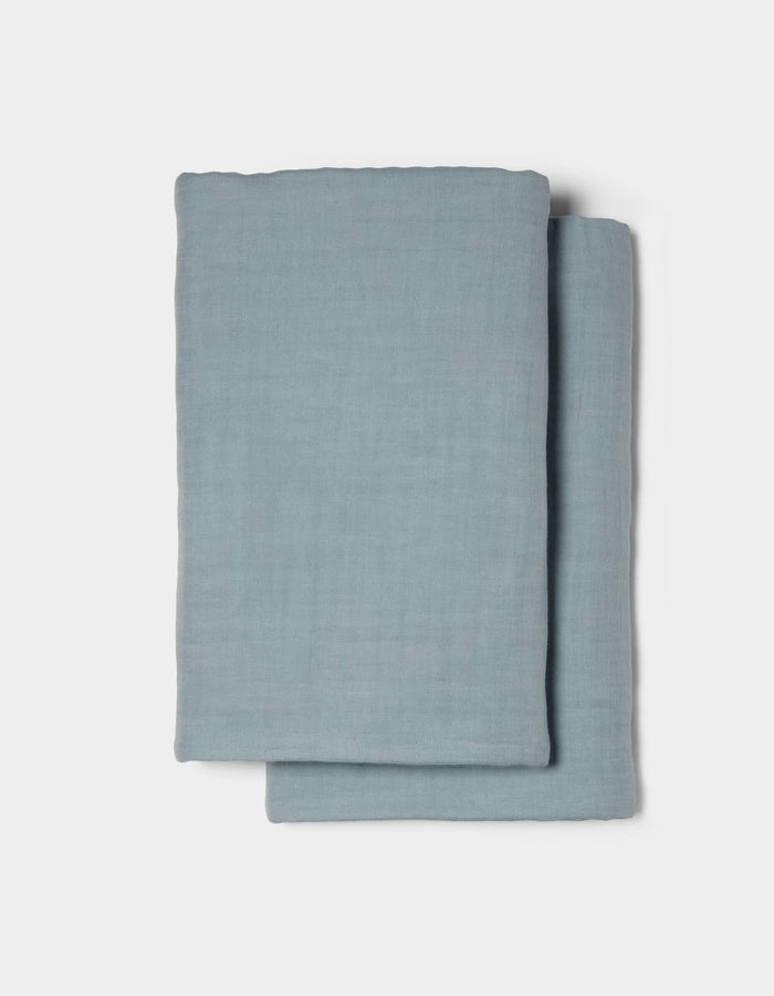 Two neatly folded Waterfront Shams by Cozy Earth are stacked on a plain white background.|Color:River Stripe
