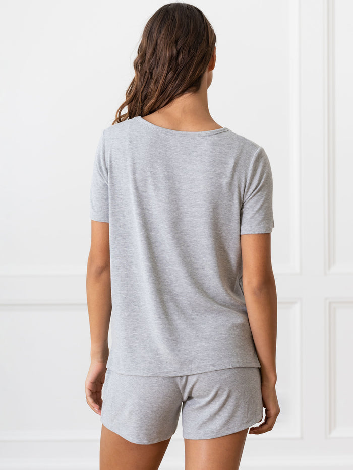 Woman wearing a grey Cozy Earth Rib Knit Short Sleeve Lounge Top and gray shorts against a white background |Color:Grey