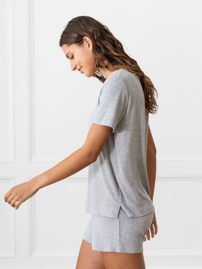 Woman wearing a grey Cozy Earth Rib Knit Short Sleeve Lounge Top and gray shorts against a white background |Color:Grey