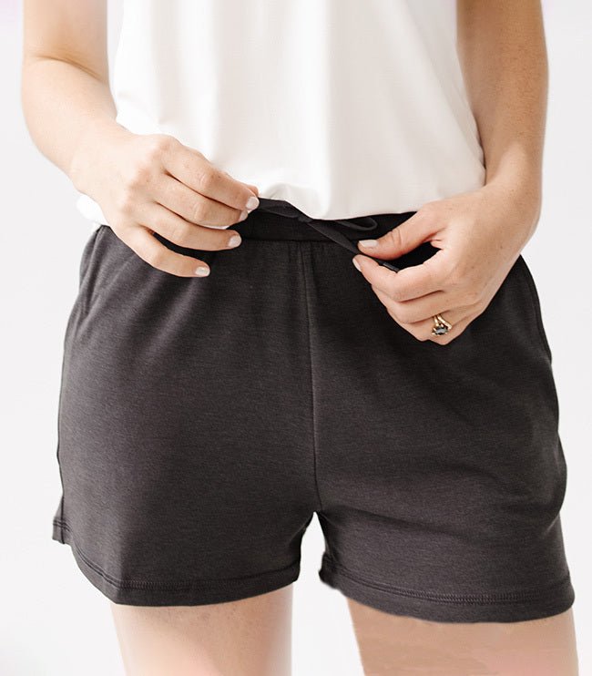 Person wearing Cozy Earth Brushed Bamboo Jogger Shorts in dark grey and a white top on a light background |Color:Charcoal