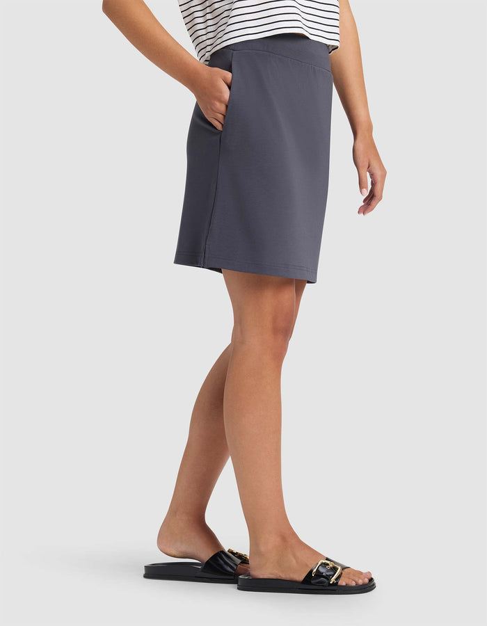 Person wearing a gray skirt and black sandals on a white background |Color:Graphite