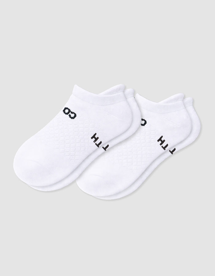 The Women's Essential Ankle Sock by Cozy Earth features a textured white design with subtle black text near the cuff, shown on a light gray background.|Color:White
