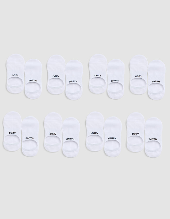 Eight pairs of white Essential No-Show Socks by Cozy Earth are arranged in three rows on a light gray background; each pair is labeled “COZY” on one sock and “EARTH” on the other. |Color:White