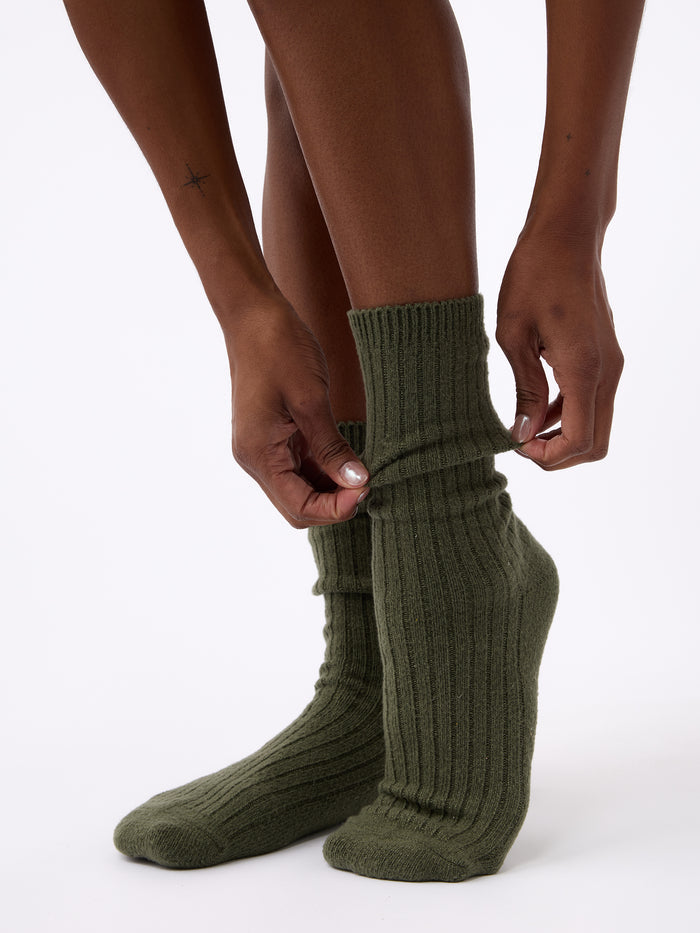 Person wearing Cozy Earth Plush Lounge Calf Sock 1-Pack in Olive |Color:Olive