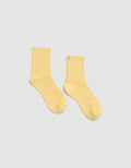 The Plush Lounge Quarter Socks by Cozy Earth in light yellow, featuring a ribbed crew design, is displayed laid flat on a light gray background.|Color:Daisy